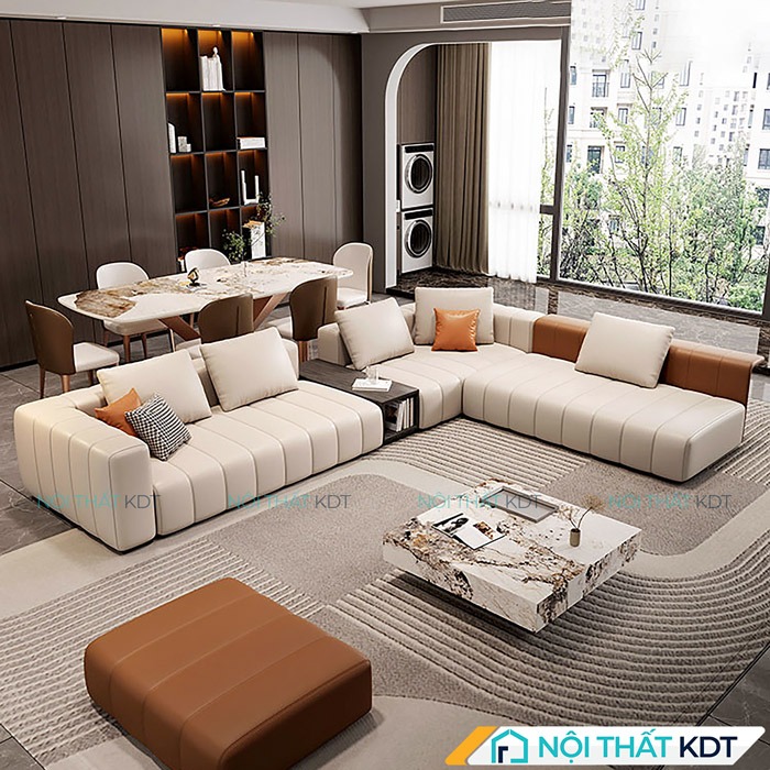 Sofa góc chữ L đặt giữa phòng khách rộng, tạo khu vực nghỉ ngơi thoải mái với thiết kế hiện đại không tay vịn, chia không gian hài hòa với khu vực bàn ăn sang trọng