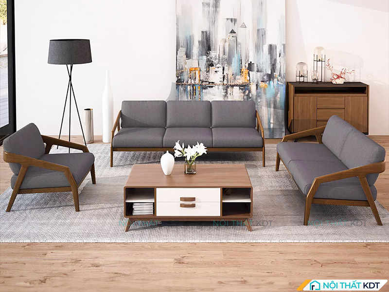 Bộ sofa văng khung gỗ đặt đối diện và vuông góc nhau, mang phong cách Bắc Âu hiện đại, tạo không gian tiếp khách sang trọng và tinh tế.